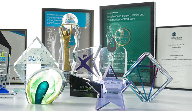 Collection of awards and trophies against a white background